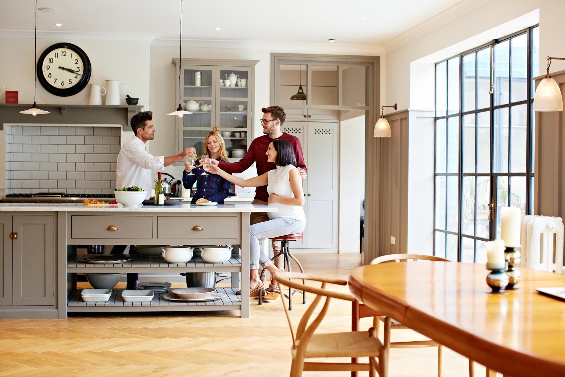 friends cheers drinks in kitchen