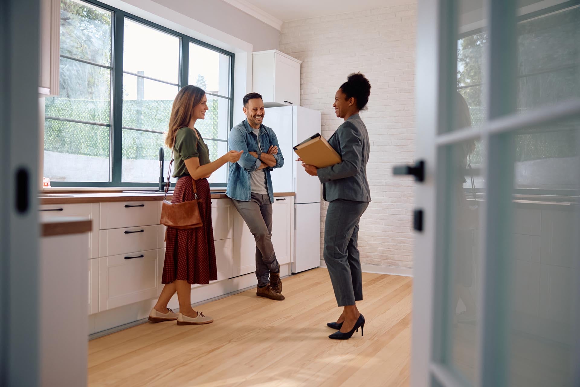 couple talking to realtor in kitchen